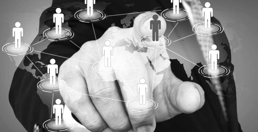 Social Network concept : hand point to social network and world map